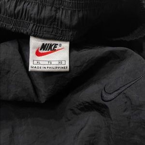 1990s vintage black Nike track pants.